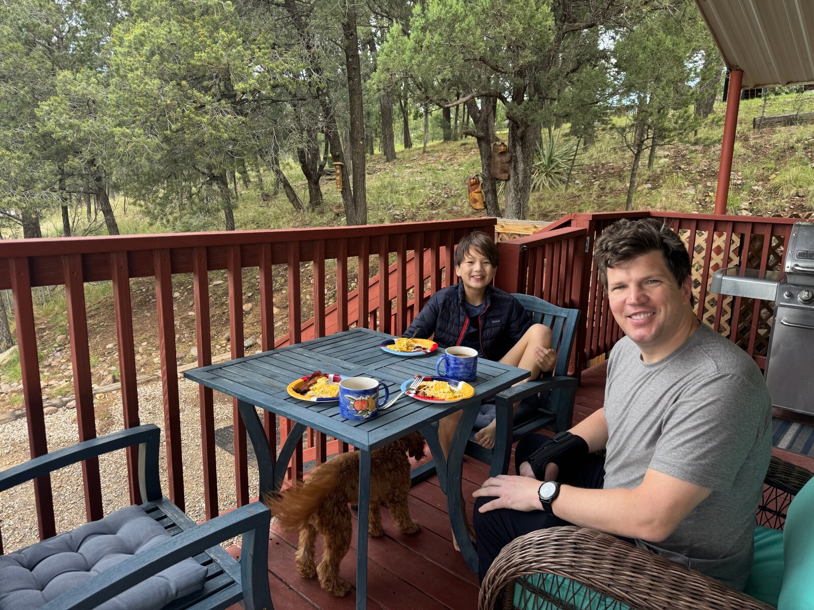 Ryan and Owen eating breakfast with Harold on the red porch